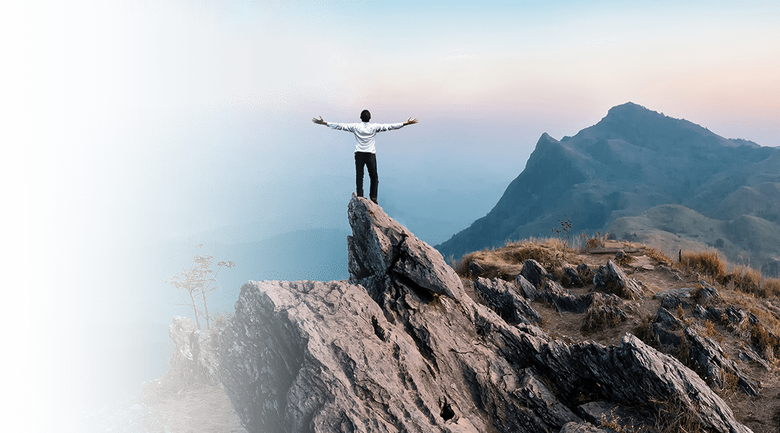 standing on a mountain